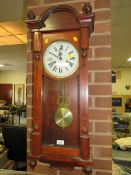 An antique Vienna wall clock in need of restoration together is a modern G Ward & sons wall clock