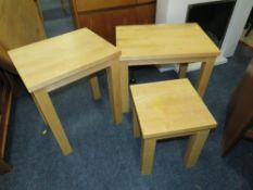 A modern oak nest of three tables