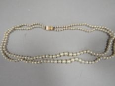 A VINTAGE SIMULATED PEARL DOUBLE STRAND NECKLACE WITH 9ct FASTENER BY CIRO