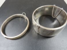 A HALLMARKED SILVER CLASP BANGLE TOGETHER WITH A SMALLER EXAMPLE