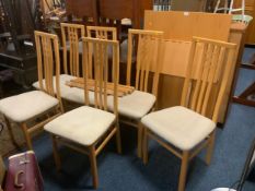 A modern beech effect extending dining table with six chairs