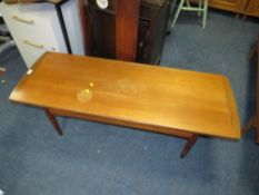 A teak mid-century coffee table with staining to the top
