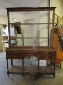 A GEORGIAN OPEN WELSH DRESSER OF SMALL PROPORTIONS, having an arrangement of five drawers, raised on