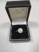 A 9ct WHITE GOLD AND DIAMOND CLUSTER RING