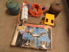 A BOX GAS CAMPING STOVE, TWO GAS BOTTLES, A CARAVAN HITCH LOCK AND A CARAVN ELECTRIC HOOK UP LEAD