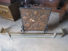 A BRASS FIRE FENDER AND COPPER PRESSED FIRE SCREEN