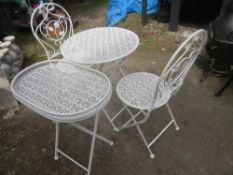 A FOLD AWAY WROUGHT IRON BISTRO SET WITH TWO CHAIRS AND A SIDE TABLE