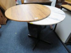 A modern bistro style pedestal table with spare top
