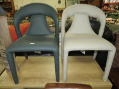 A pair of modern leather upholstered designer style dining chairs