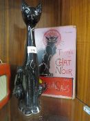 A VINTAGE BLACK CERAMIC CAT TOGETHER WITH A REPRODUCTION TOURNEE DU CHAT NOIR ENAMEL SIGN