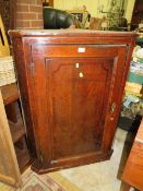 A Georgian oak cross banded hanging corner cupboard