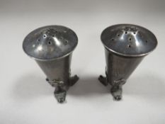 A PAIR OF ARTS AND CRAFTS SILVER PEPPERS BY A.E. JONES H.M. BIRMINGHAM 1906
