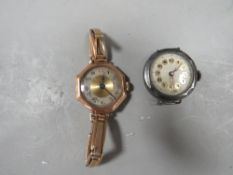 A hallmarked gold ladies wrist watch on expandable bracelet together with a silver example