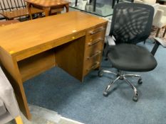 A modern single pedestal desk together with an office armchair