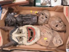 An Indonesian tribal art Dayak Borneo ancestor figure and four Dayak tribal masks