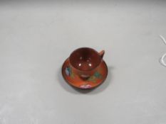 A Wedgwood terracotta ( Rossi ) hand painted miniature cup and saucer