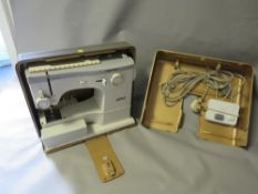 A cased vintage sewing machine
