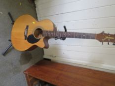 A Jasmin S34C acoustic guitar with stand