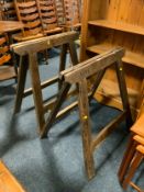 A pair of vintage wooden trestles stamped ‘Bass’