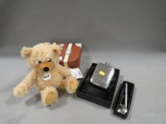A modern boxed small steiff bear together with a silver plated hip flask etc