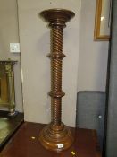A modern mahogany torchiere stand