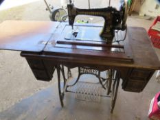 An antique Bradburys sewing machine and cast iron stand