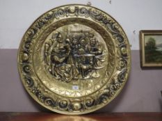 A large circular brass plaque