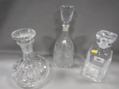 A ships decanter together with two others