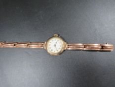 A vintage 9 carat gold watch on expanded plated bracelet
