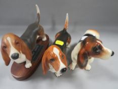 Three basset hound figures to include Beswick