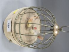 A vintage jewellery box automaton with a bird sat upon a swing