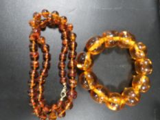 An Amber necklace and Amber style bracelet containing insects