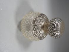 An antique silver mounted cutglass scent bottle H.M. London 1902