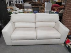 A modern cream leather three seater settee