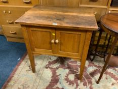 A small oak two door cabinet with marked top