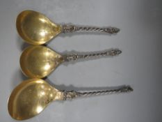 Three decorative 19th century white metal spoons with gilded bowls and figural knobs