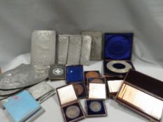 A tray of assorted cased medallions and collectables to include measuring instruments