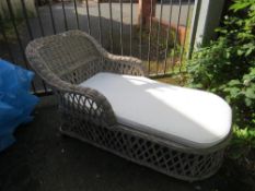 A wicker conservatory chaise longue