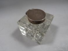 An antique silver mounted cutglass inkwell H.M. Sheffield 1907