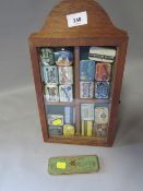 A small display case containing gramophone needle tins