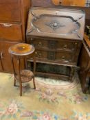 A traditional oak 1930s carved bureau together with a oak plant stand