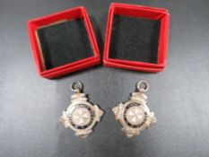 Two vintage hallmarked silver St Johns fobs in boxes