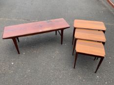 A mid-century teak coffee table together with a nest of tables