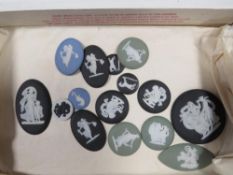 A box of Wedgwood jasperware medallions to include a white/black example