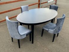 A set of four upholstered dining chairs together with a modern dining table