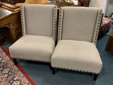 A pair of modern upholstered studded large chairs