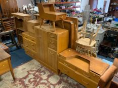 A mid-century utility oak tallboy and dressing table, chest of drawers, and two smaller cabinets