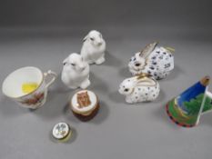 A selection of ceramics to include Royal Crown Derby paperweights, Royal Worcester miniature cup etc