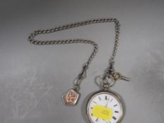 A Continental silver pocket watch on graduating chain with hallmarked silver locket with gold