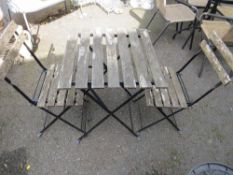 A folding garden bistro set comprising a table and two chairs